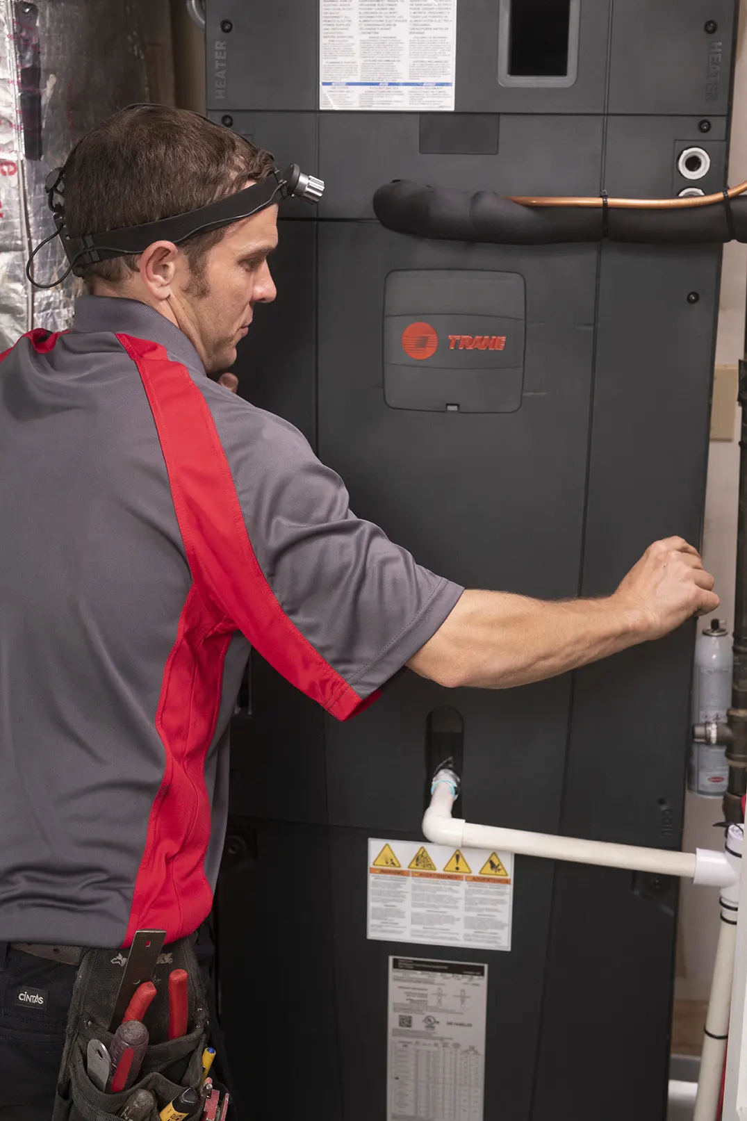 HVAC Service Tech working on furnace front panel at air handler | Epic A/C Service | epicacguy.com