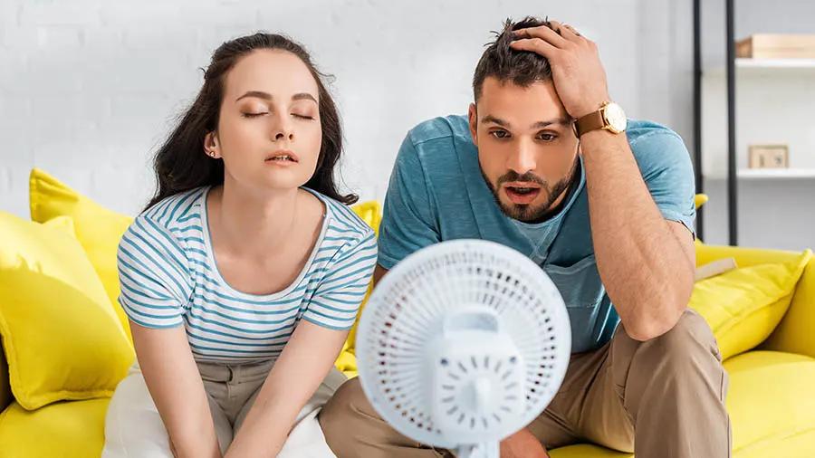 Hot Couple in front of fan | Epic A/C Service | epicacguy.com